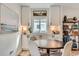 Cozy dining area features a round table with seating for four and built-in cabinets for storage at 1010 S Newton St, Denver, CO 80219