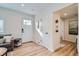 A view of the foyer, adjacent to the living room, with stylish accents and ample lighting at 1010 S Newton St, Denver, CO 80219