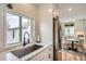 Bright kitchen features stainless steel appliances, a window over the sink, and an adjacent dining area at 1010 S Newton St, Denver, CO 80219