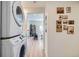 Convenient laundry area with stacked washer and dryer, and views into the living room at 1010 S Newton St, Denver, CO 80219