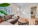 A cozy living room featuring hardwood floors, comfortable seating, and ample natural light at 1010 S Newton St, Denver, CO 80219