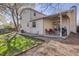 Spacious backyard with a covered patio, grill, and well-maintained lawn, ideal for outdoor gatherings at 14867 E Pacific Pl, Aurora, CO 80014