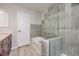 Beautifully tiled bathroom featuring a shower and soaking tub with updated fixtures at 14867 E Pacific Pl, Aurora, CO 80014