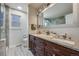 Bathroom vanity with granite countertops, dual sinks, and a large mirror at 14867 E Pacific Pl, Aurora, CO 80014