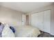 Comfortable bedroom with a queen-size bed, laminate flooring, and closet at 14867 E Pacific Pl, Aurora, CO 80014