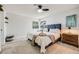 Well-lit bedroom with a tray on the bed, side table, and decor at 14867 E Pacific Pl, Aurora, CO 80014