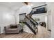 Inviting entryway with a wood staircase, chair, and wood-look floors at 14867 E Pacific Pl, Aurora, CO 80014