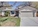 Charming home featuring a two-car garage, manicured lawn and mature landscaping at 14867 E Pacific Pl, Aurora, CO 80014