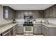 Kitchen features stainless steel appliances, granite countertops, and refaced cabinets at 14867 E Pacific Pl, Aurora, CO 80014
