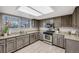 Well-lit kitchen featuring stainless steel appliances, granite countertops and newly refinished cabinets at 14867 E Pacific Pl, Aurora, CO 80014