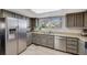 Spacious kitchen features stainless steel appliances and granite countertops with a window view at 14867 E Pacific Pl, Aurora, CO 80014