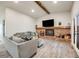 Comfortable living room featuring a cozy brick fireplace, mantel, and neutral furnishings at 14867 E Pacific Pl, Aurora, CO 80014