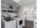 A tidy laundry area with shelving and a laundry machines at 19454 E Florida Pl, Aurora, CO 80017