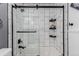 Modern shower featuring white subway tile, black fixtures, and a glass door at 19454 E Florida Pl, Aurora, CO 80017