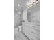 Bright bathroom featuring a marble tiled shower with glass doors, chrome fixtures, and modern vanity at 1700 Bassett St # 1301, Denver, CO 80202