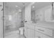 This bathroom features a marble tiled shower with glass doors and chrome fixtures with a modern sink at 1700 Bassett St # 1301, Denver, CO 80202