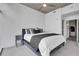 Cozy bedroom with cityscape views from large windows, plush bedding, and stylish side table at 1700 Bassett St # 1301, Denver, CO 80202