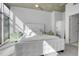 Bright bedroom featuring city views, a white bed, and a concrete ceiling at 1700 Bassett St # 1301, Denver, CO 80202