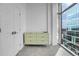 This bedroom features a light green dresser with large picture windows providing ample natural light at 1700 Bassett St # 1301, Denver, CO 80202