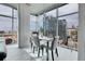 Contemporary dining room with a glass table, modern chairs, and large windows providing city views at 1700 Bassett St # 1301, Denver, CO 80202