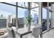 Modern dining room with city views through expansive windows and a contemporary chandelier at 1700 Bassett St # 1301, Denver, CO 80202
