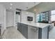 Modern kitchen with island, stainless steel appliances, and open layout connecting to a comfortable living area at 1700 Bassett St # 1301, Denver, CO 80202