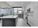 Modern kitchen featuring white cabinets, stainless steel appliances, and a large island with city views at 1700 Bassett St # 1301, Denver, CO 80202