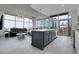 Open concept living area with modern kitchen island, sleek countertops, and large windows showcasing city views at 1700 Bassett St # 1301, Denver, CO 80202