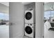 Convenient in-unit laundry closet with stacked washer and dryer units, located off main living space at 1700 Bassett St # 1301, Denver, CO 80202