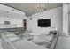 Stylish living room with a modern kitchen, white brick wall, and comfortable gray sofa at 1700 Bassett St # 1301, Denver, CO 80202