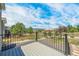 Expansive balcony view showcases lush greenery and neighborhood charm under a bright, partly cloudy sky at 670 Portland Rd, Monument, CO 80132
