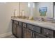 Bathroom with a dual sink vanity, granite counter, and decorative backsplash at 670 Portland Rd, Monument, CO 80132