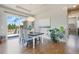 Bright dining room with modern light fixture, wooden floors, and sliding door access to the backyard at 670 Portland Rd, Monument, CO 80132