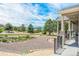 Picturesque covered patio overlooks gravel landscaping, shrubbery, and native trees at 670 Portland Rd, Monument, CO 80132