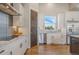 Well-lit kitchen featuring white cabinets, stainless steel appliances, and hardwood floors for a modern look at 670 Portland Rd, Monument, CO 80132