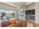Bright living room with a stone fireplace, large windows, and a comfortable leather sectional sofa at 670 Portland Rd, Monument, CO 80132
