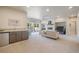 Open living room features a wet bar, fireplace with mantel and a walk out to the outdoor patio at 670 Portland Rd, Monument, CO 80132