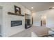 Contemporary living room fireplace with mantel, television, and recessed lighting at 670 Portland Rd, Monument, CO 80132