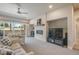 Cozy living room features a fireplace with mantel, a ceiling fan and access to the outdoor living space at 670 Portland Rd, Monument, CO 80132