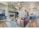 Open concept living area featuring a stone fireplace and seamless flow to the kitchen and dining spaces at 670 Portland Rd, Monument, CO 80132