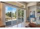 Spacious living room featuring a stone fireplace, large windows, and views of the serene outdoor landscape at 670 Portland Rd, Monument, CO 80132
