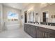 Main Bathroom has marble floors, stand alone tub, double sinks and lots of light at 670 Portland Rd, Monument, CO 80132