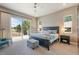 Serene main bedroom with balcony access, plush carpeting, and elegant furnishings for a relaxing retreat at 670 Portland Rd, Monument, CO 80132