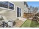 Backyard area with artificial grass, stone landscaping, and a sliding glass door entrance at 7822 South Kittredge Circle, Englewood, CO 80112