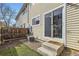 Backyard featuring artificial grass, stone landscaping, and a sliding glass door entrance at 7822 South Kittredge Circle, Englewood, CO 80112