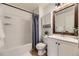 Bright bathroom featuring subway tile, white vanity, framed mirror, and bathtub with shower at 7822 South Kittredge Circle, Englewood, CO 80112