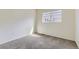 This carpeted bedroom is well lit by a window, and has neutral-colored walls at 7822 South Kittredge Circle, Englewood, CO 80112