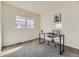 Sunlit bedroom featuring a desk, chair, and window with neighborhood views at 7822 South Kittredge Circle, Englewood, CO 80112