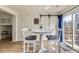 Bright dining area features wood floors, a round table, and sliding glass doors to the outside at 7822 South Kittredge Circle, Englewood, CO 80112