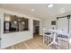 Cozy dining area with a white table, gray chairs, and modern lighting fixtures at 7822 South Kittredge Circle, Englewood, CO 80112